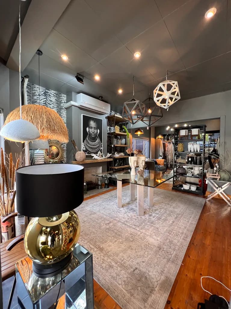 Showroom display with lamps, pendant lights, mirrors, rugs and decor pieces