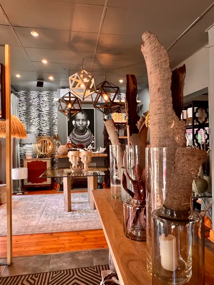 Patterned wallpaper, lighting, furniture and decorative details in a coordinated interior